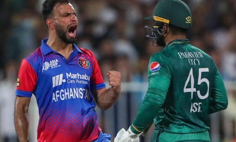 Naveen Ul Haq celebrates after taking a Pakistan wicket