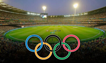 Olympics logo shown with a stadium in the background