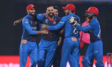 Afghan team celebrates a wicket with Mohammad Nabi