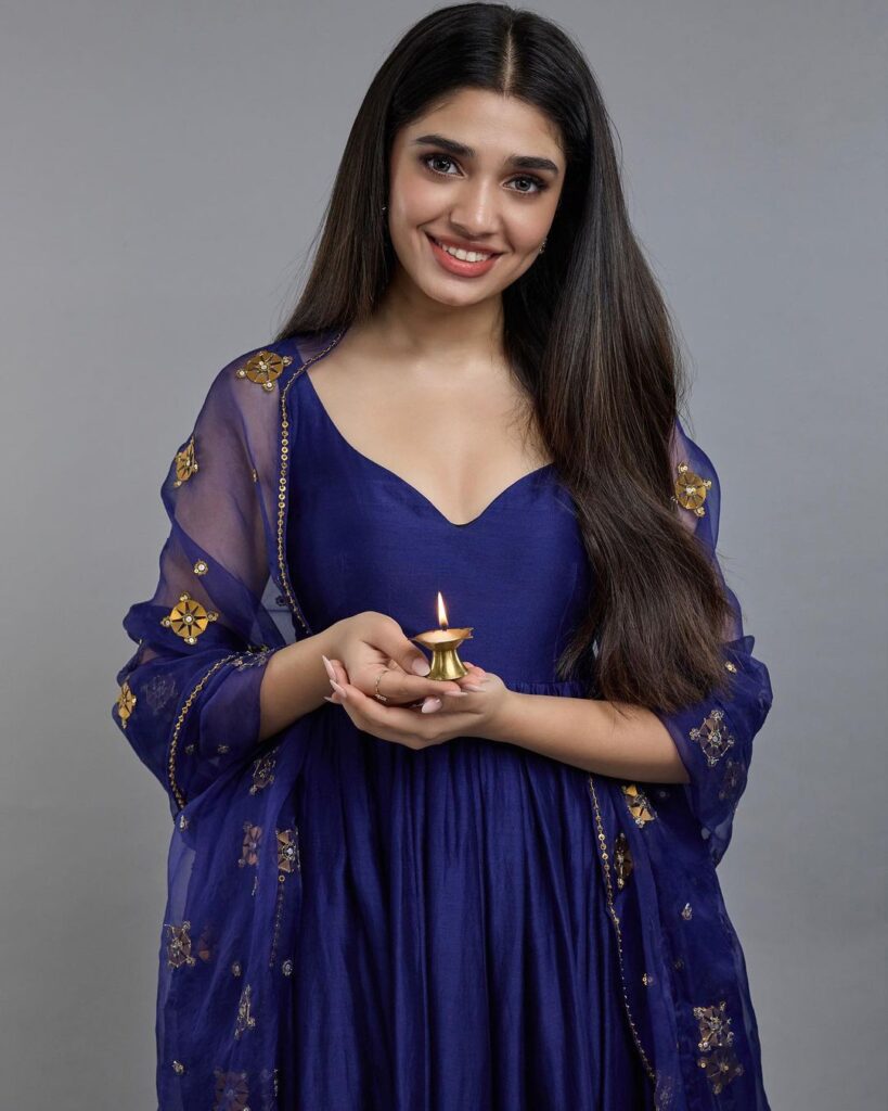  Krithi Shetty dons a stunning blue anarkali suit with intricate gold embroidery.