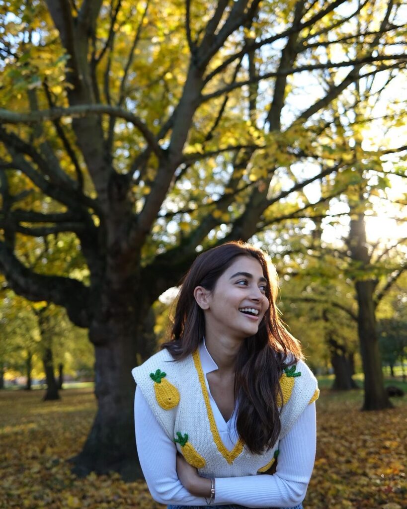 Pooja Hegde in a cozy sweater, surrounded by park serenity