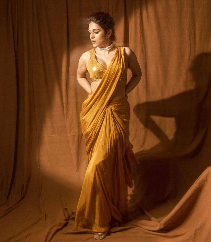 Shraddha Das elegantly poses in a vibrant yellow saree