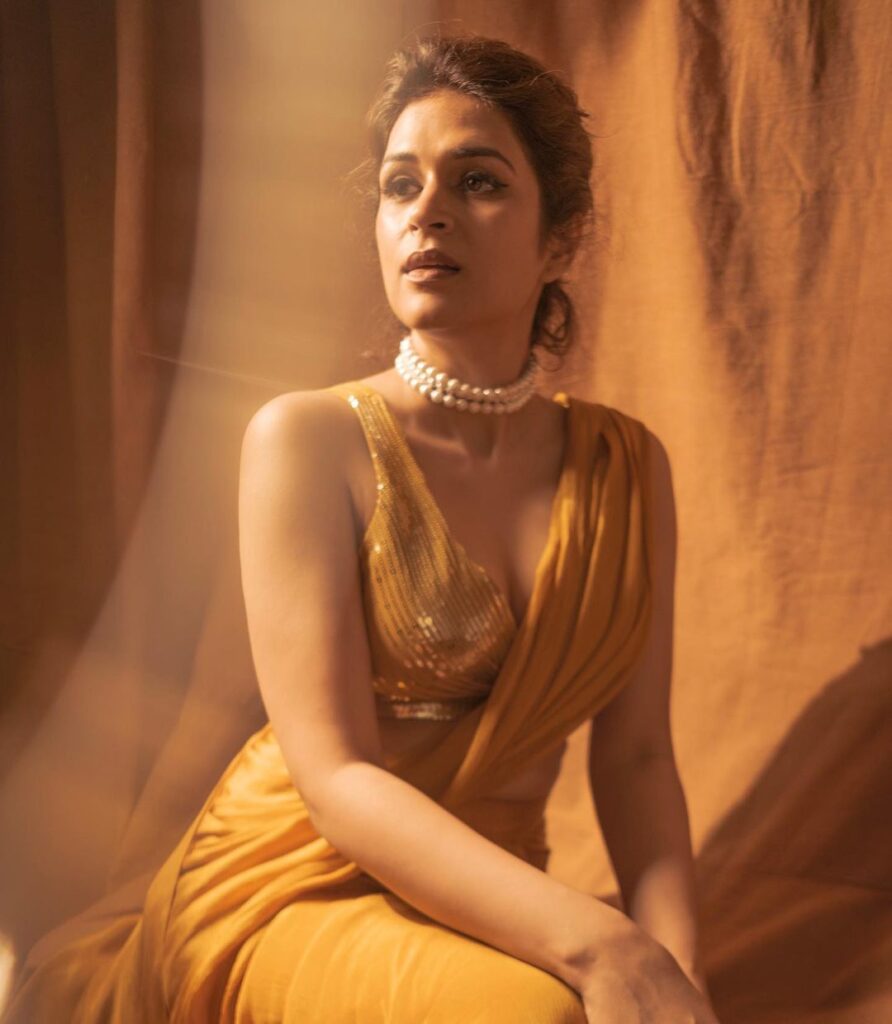Actress Shraddha Das in a glamorous yellow saree