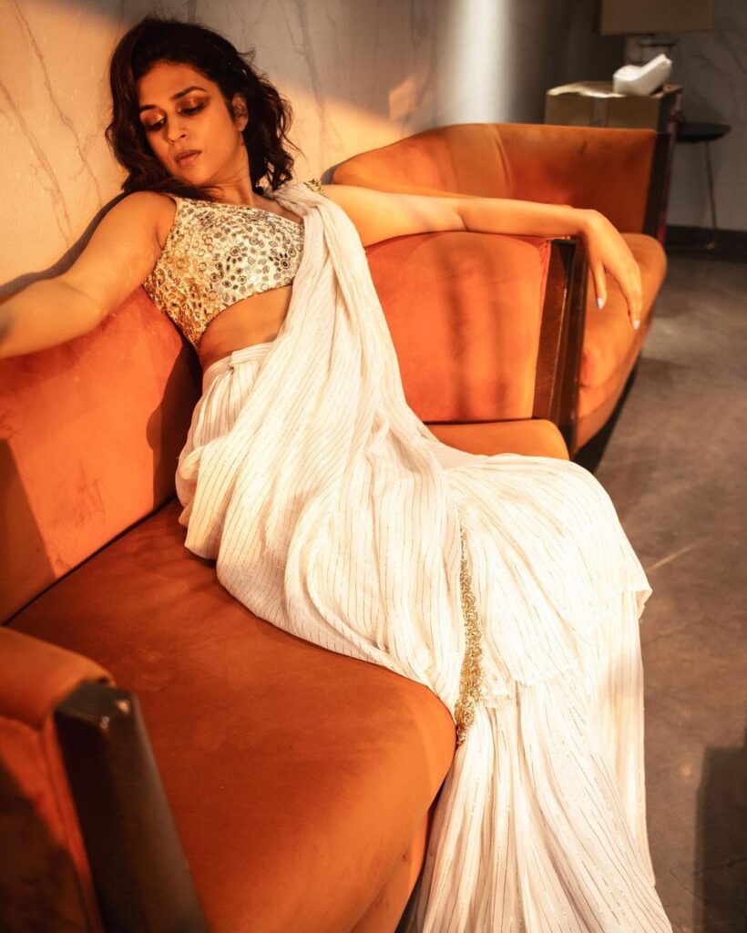 Graceful poses complementing Shraddha Das in a serene white saree