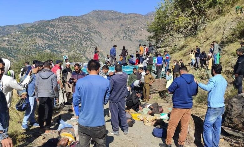 People gather at the accident site in Jammu and Kashmir's bus accident.
