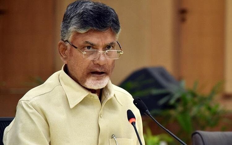 Chandrababu Naidu in press conference looking over his spectacles.