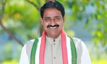 Patel Ramesh Reddy of Congress party, Telangana, smiling with a Congress scarf.