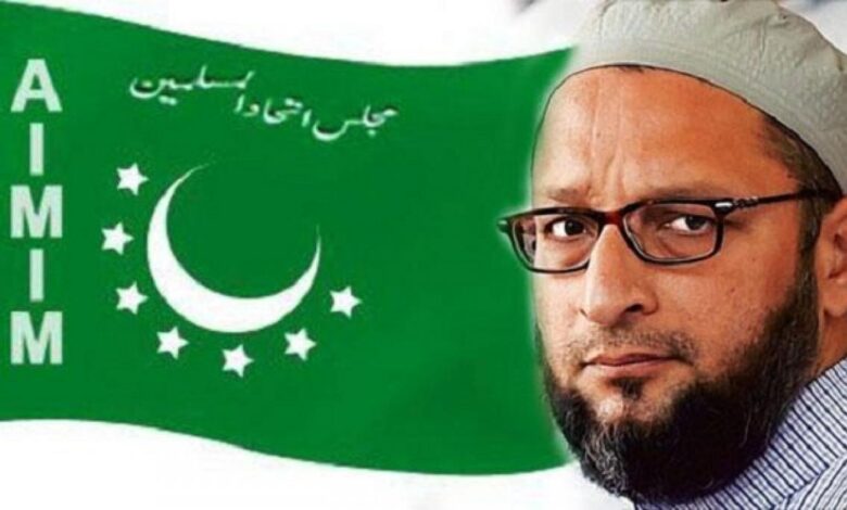 AIMIM chief Asaduddin Owaisi with the party flag in the background.