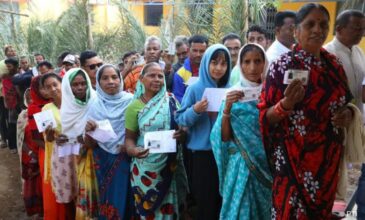 Women stand in line for polling their vote in Assembly elections.