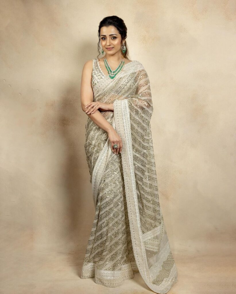 Trisha looks really graceful in her pretty white and green saree