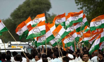 Congress flags waving at a party rally.