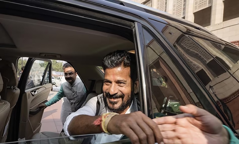 CM Revanth Reddy shaking people's hands from his car.