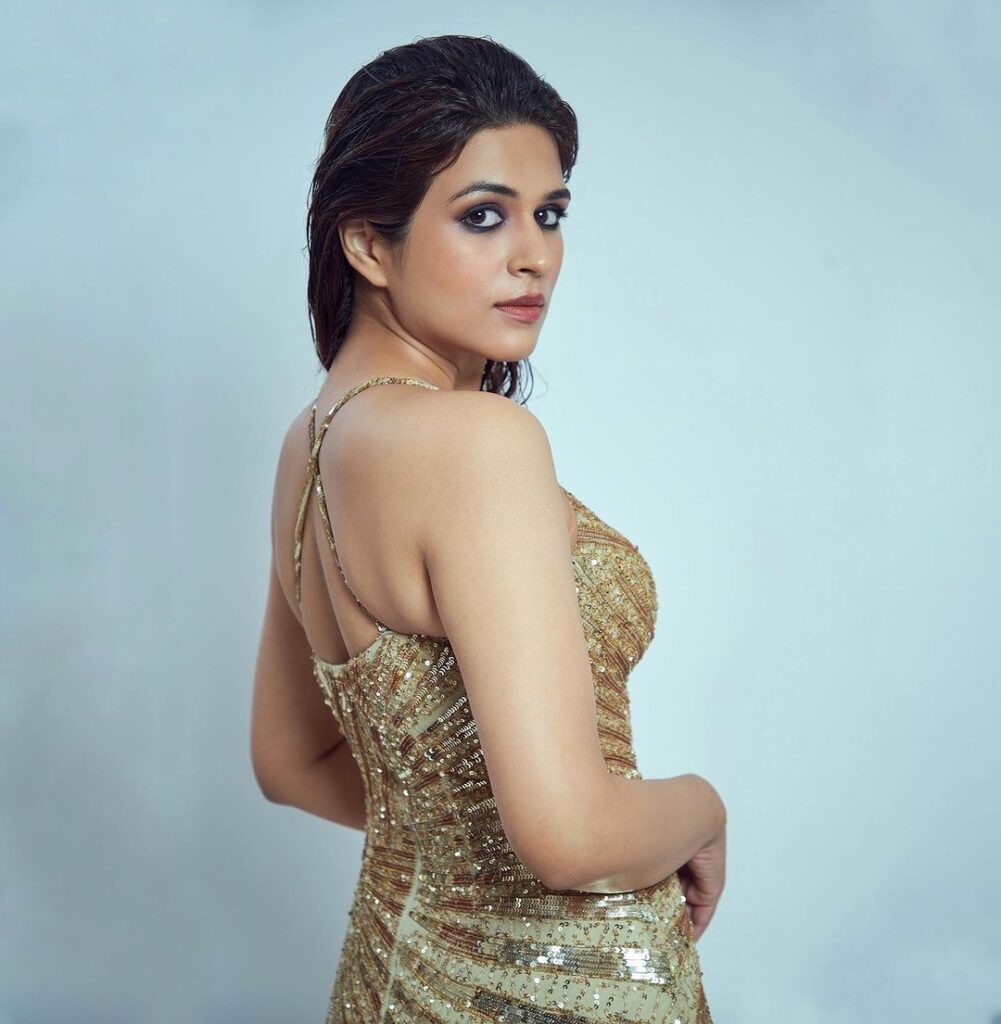 Shraddha Das dons a striking golden dress complemented by elegant pearl adornments