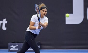 Sania Mirza playing tennis wearing a trouser.