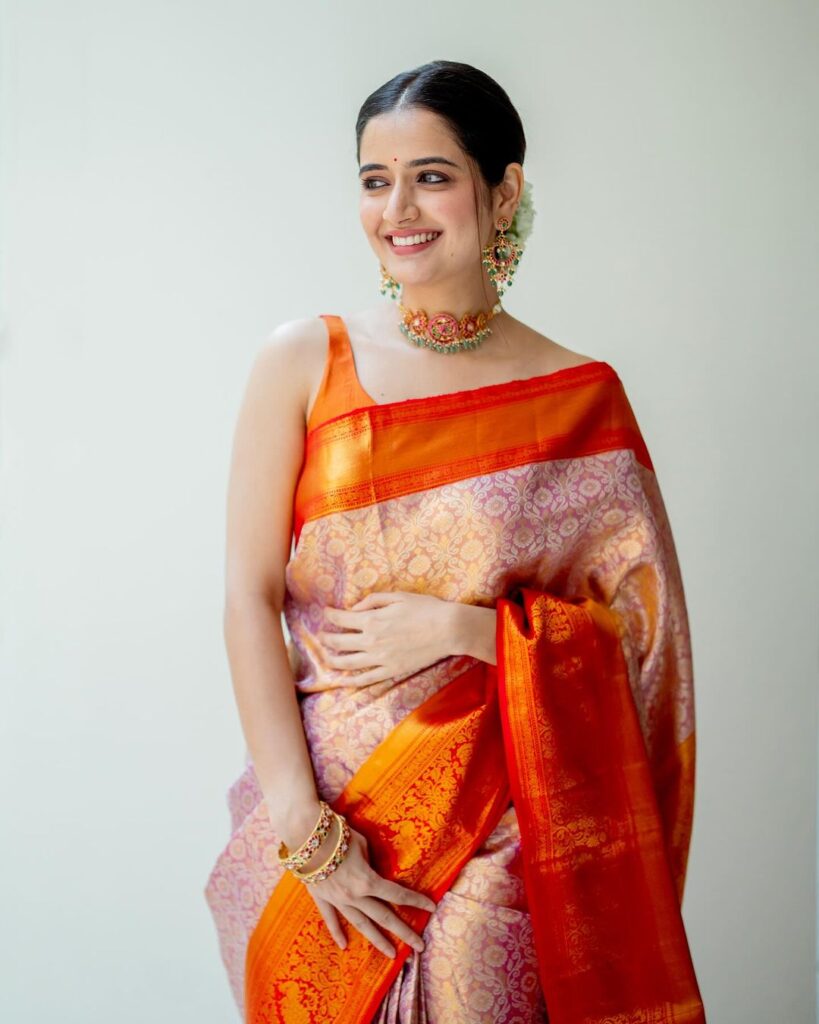 Ashika Ranganath captivates in stunning orange drape with smile