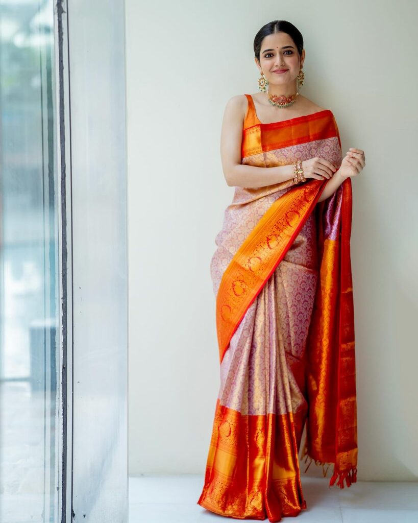 Ashika Ranganath dazzles in traditional orange drapes