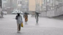 People in rain with umbrellas.