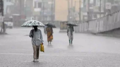 People in rain with umbrellas.