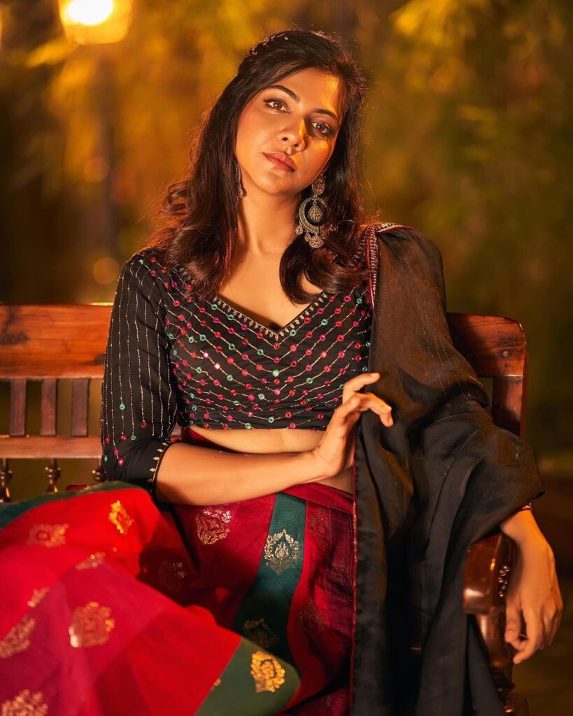 Captivating red and black photoshoot featuring Madonna Sebastian's cultural charm