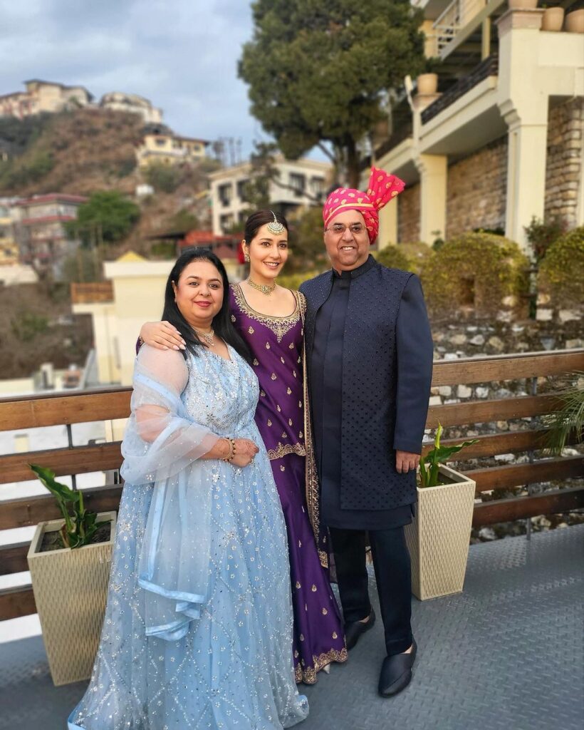 Raashii Khanna in traditional purple dress with family in hilly urban setting