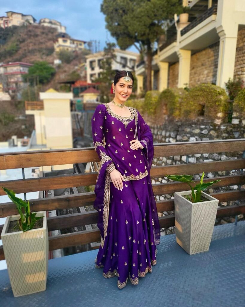 Raashii Khanna in traditional purple dress in hilly urban setting