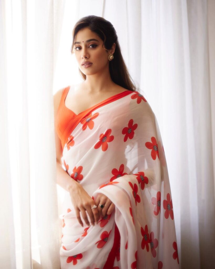 Janhvi Kapoor in a white and red floral saree with a sleeveless red blouse