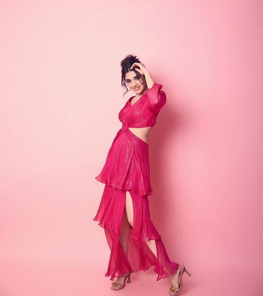 Krithi in a stylish pink cutout dress, showcasing her chic fashion sense