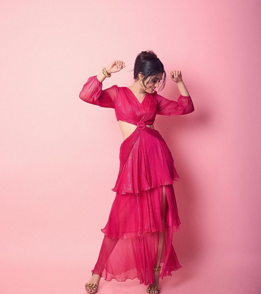 Krithi shines in a pink dress with strategic cutouts and gold accessories