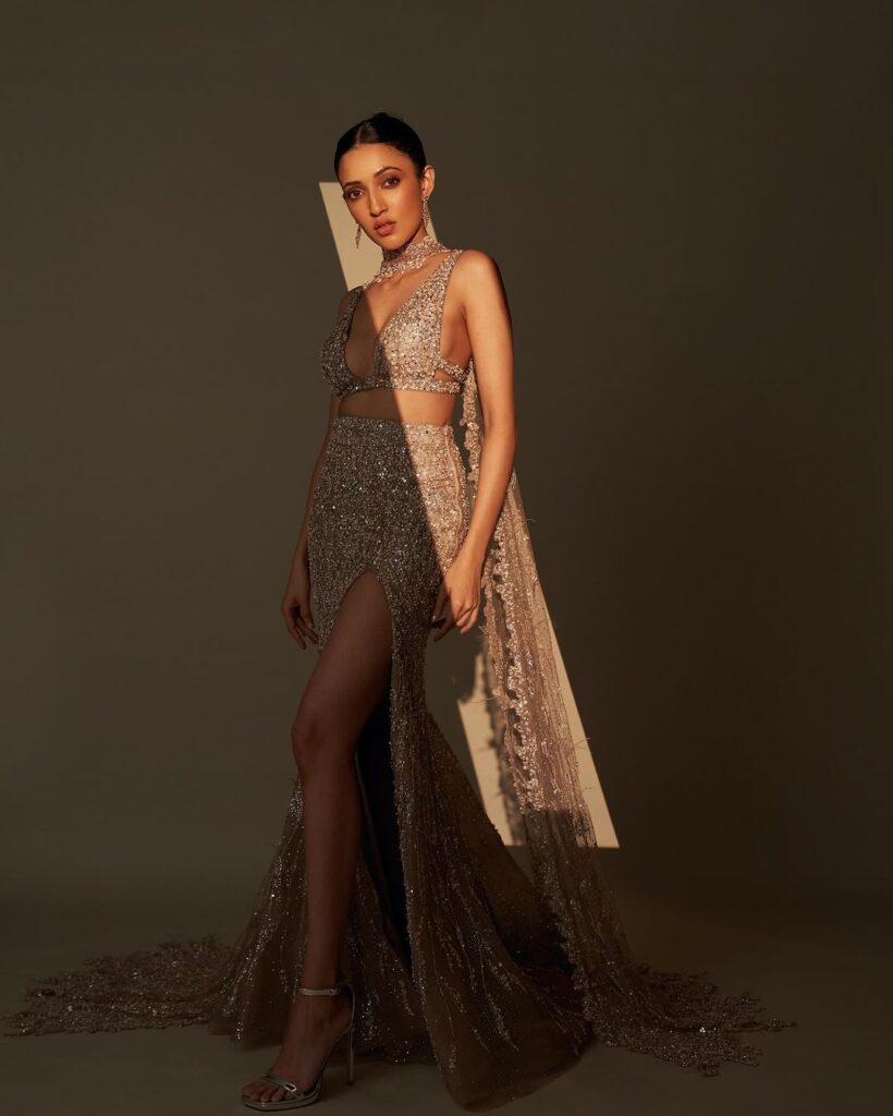Neha Shetty dazzling in golden sequined bralette and thigh-high slit skirt