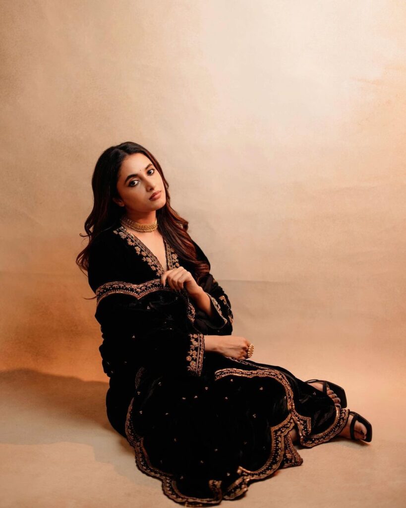 Priyanka Mohan sitting on Floor in sleek black ensemble