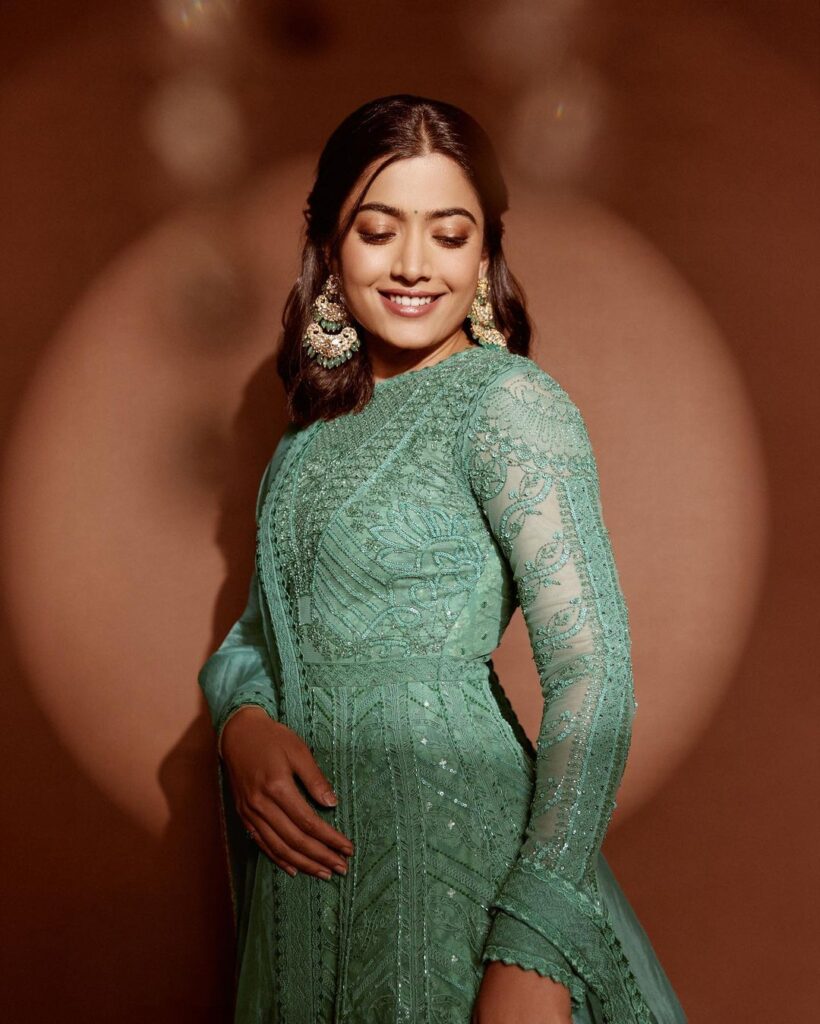 Rashmika Mandanna in green netted long frock, hair loose, ear jhumkas with smile