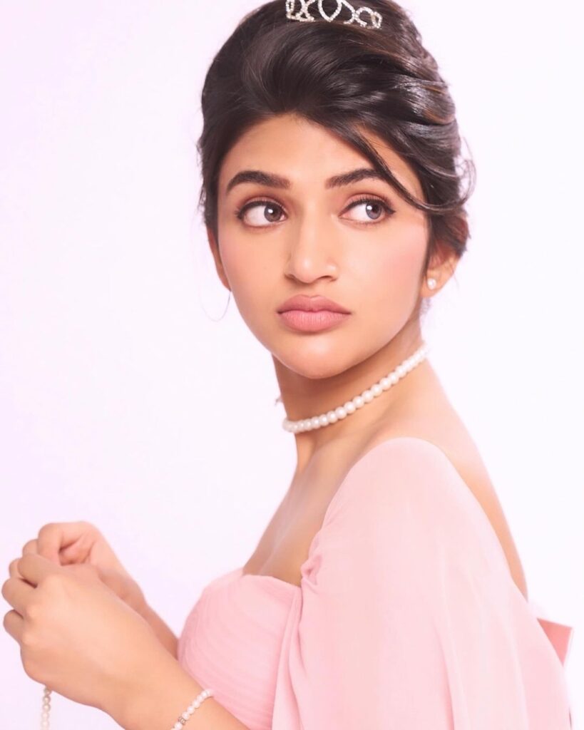 Sreeleela in pink dress, bun, accentuated by pearls
